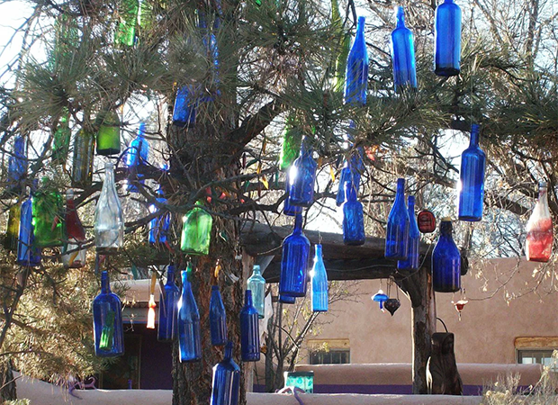 colored glass bottles hanging in a tree